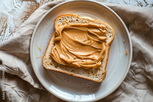 a piece of bread with peanut butter on a plate