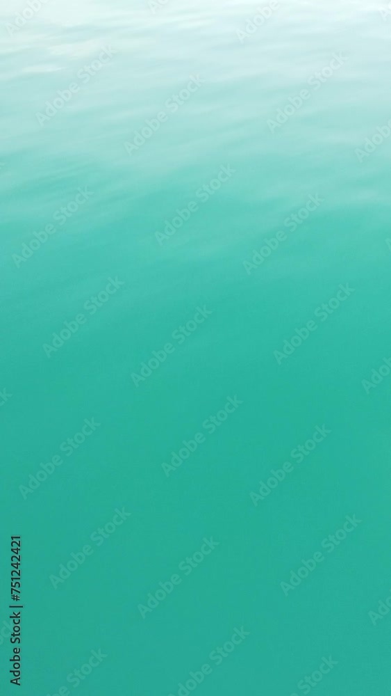 Vertical aerial view over calm azure sea water surface. Sun glare. Abstract nautical summer ocean nature. Holiday, vacation and travel concept. Nobody. Weather and climate change Vertical aerial view over calm azure sea water surface. Sun glare. Abstract nautical summer ocean nature. Holiday, vacation and travel concept. Nobody. Weather and climate change