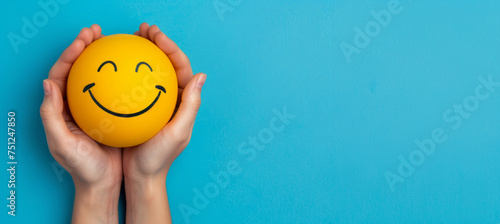 Hand holding happy smile face and sad paper cut, Positive thinking, Mental health assessment , World mental health day concept. A person is holding two smiley faces in their hands. faces are smiling photo