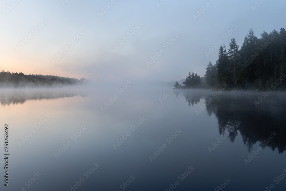 Dawn over a fog covered lake Dawn over a fog covered lake
