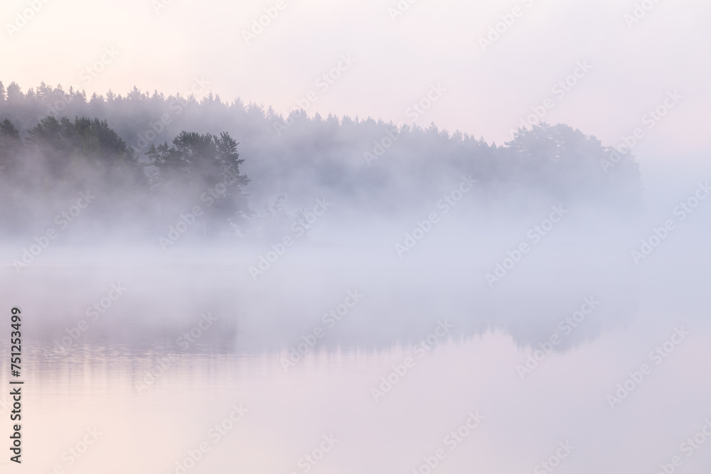 Dawn over a fog covered lake