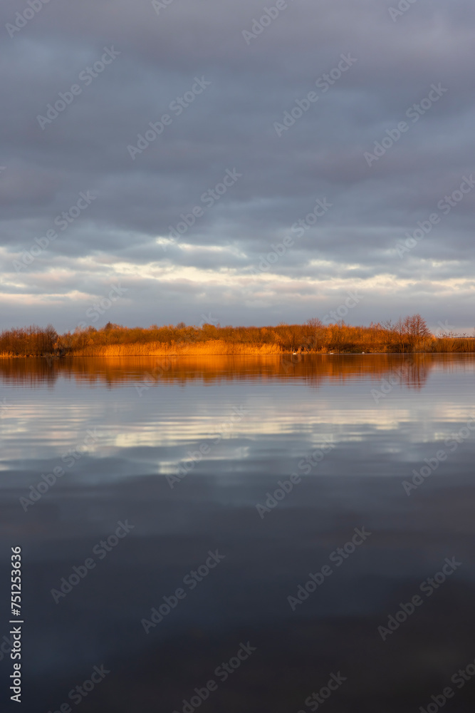 a large lake in winter in the morning during sunrise