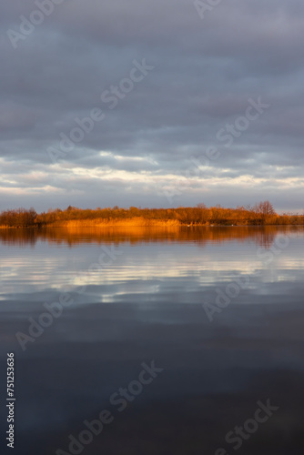 a large lake in winter in the morning during sunrise © rsooll