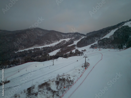 Aerial top view of Ski resort with snow mountain, sport recreation in winter season.