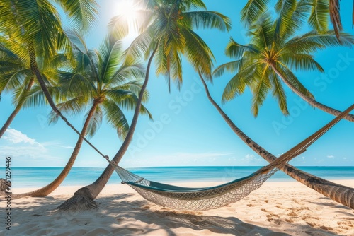 A hammock is stretched between palm trees against the backdrop of a beautiful golden sunny beach and blue ocean. AI generative © tiena