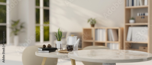 A presentation space on a round marble coffee table in a modern, minimal bright living room.