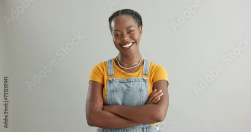 Fashion, happy and arms crossed with black woman in studio on white background for trendy style. Portrait, confident and smile with proud young person in casual clothing outfit for satisfaction photo