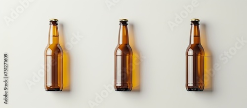 Three beer bottles are suspended on a wall, showcasing their empty interiors. The bottles are arranged in a row, creating a simple yet impactful visual.