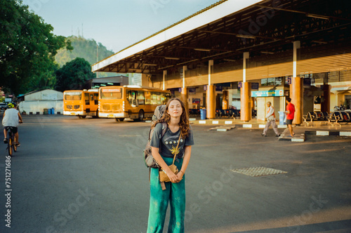 Woman backpacker on bus station photo