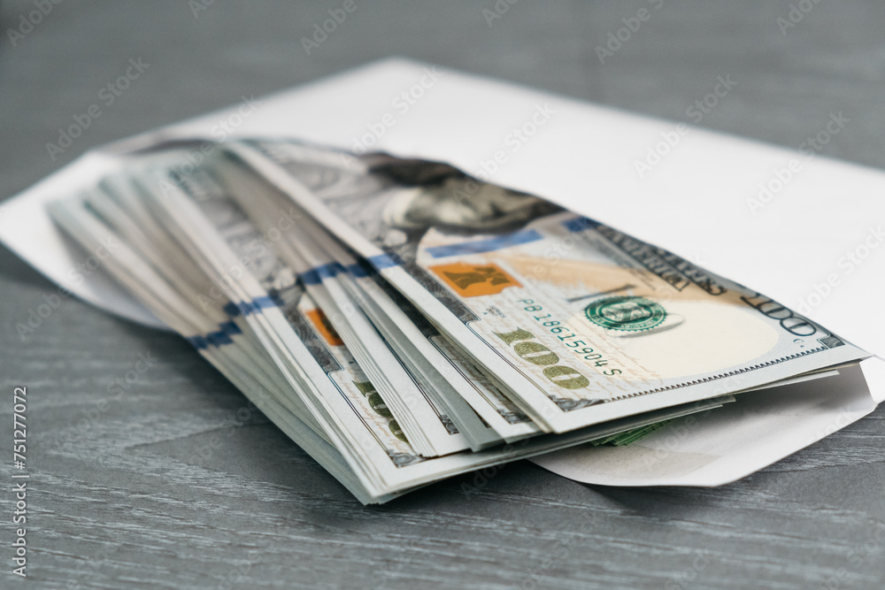 Close-up of money in an envelope. Concept of bribe, corruption, salary, earnings and financial savings. Close-up of money in an envelope. Concept of bribe, corruption, salary, earnings and financial savings.