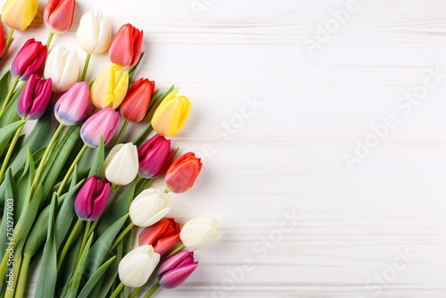 a group of colorful tulips on a white surface
