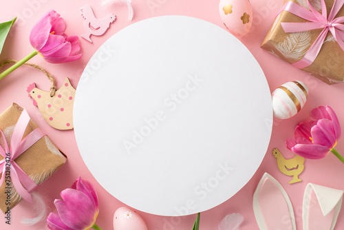 Easter happiness motif: Top view of vivid eggs, cute wooden chick decorations, kraft gift boxes with bows, playful bunny ears, and fresh tulips on pastel pink backdrop, round space reserved for words