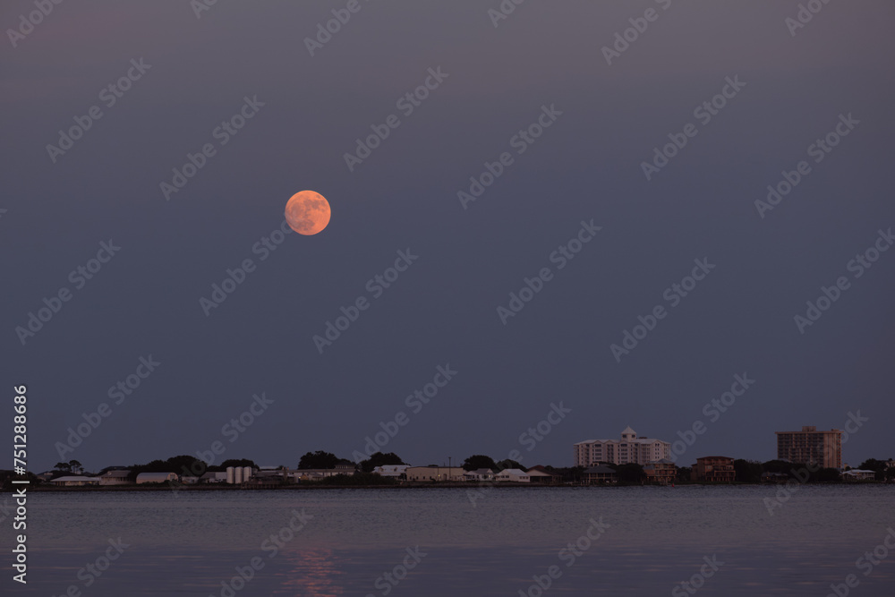 Pink Full Moon over Town Skyline with Copyspace