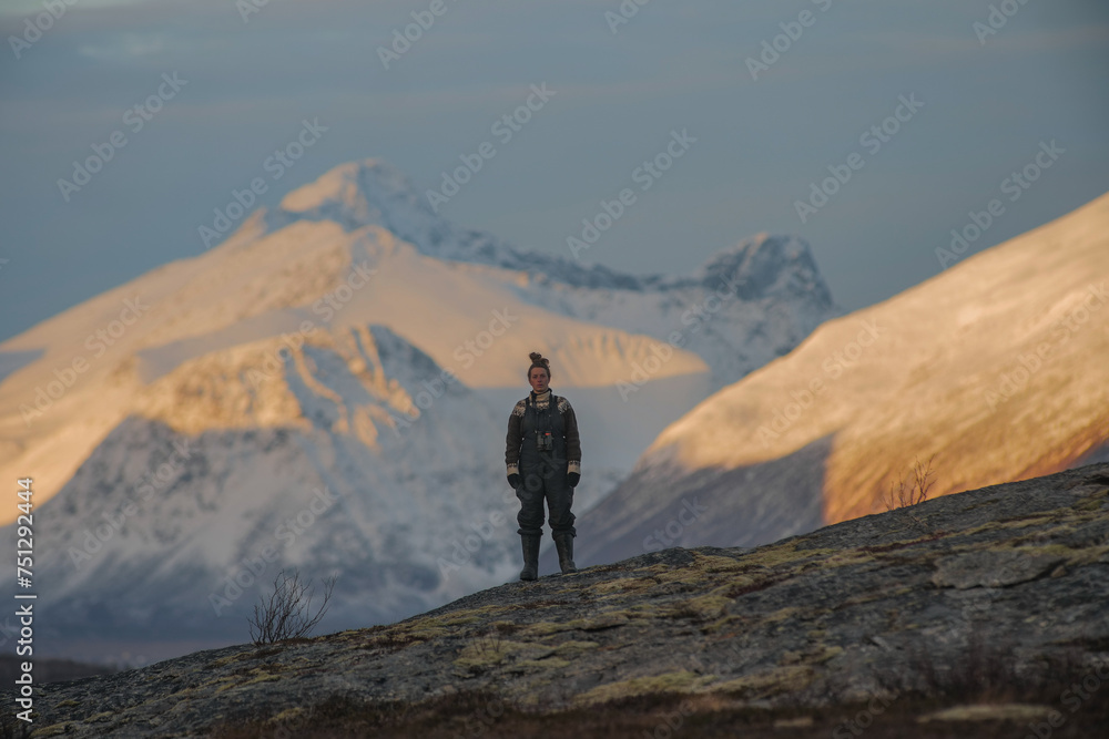Woman in front of a snow covered mountain Woman in front of a snow covered mountain