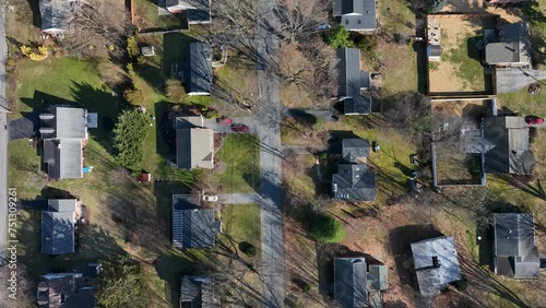 American Population with Houses in rural area of Pennsylvania. Sunny day with leafless trees in winter. Aerial top down flyover.