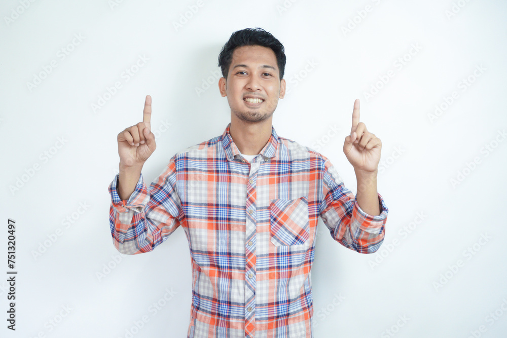 Adult Asian man smiling happy and pointing both hands up Adult Asian man smiling happy and pointing both hands up