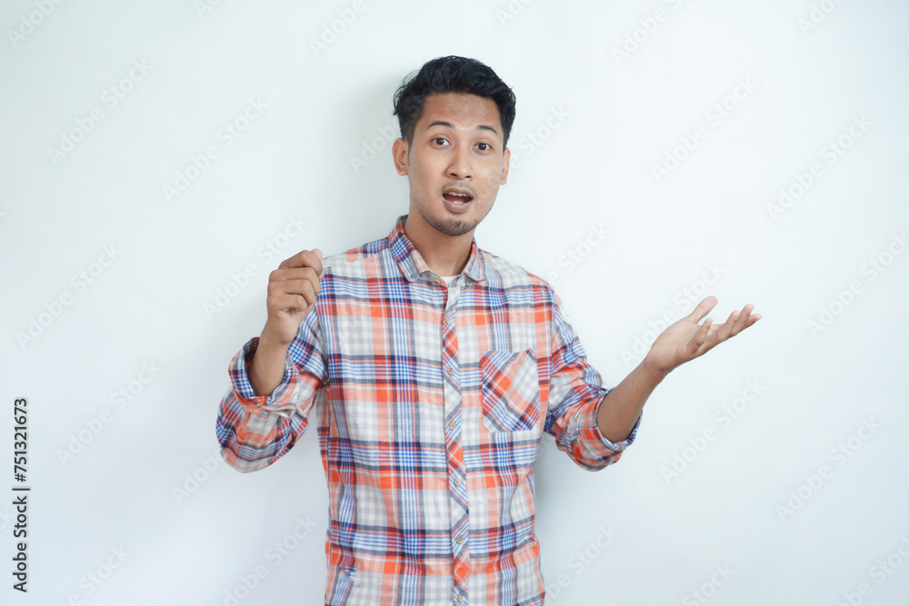 Adult Asian man showing shocked expression with both hands pointing to the right side Adult Asian man showing shocked expression with both hands pointing to the right side