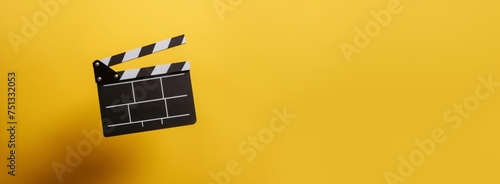 Clapperboard, movie slate, used in film production and cinema, movies industry isolated over bright yellow background