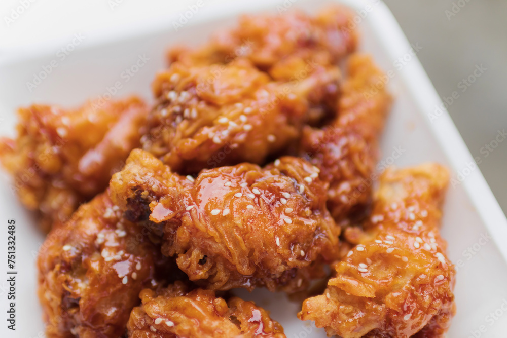 Deep fried chicken wing with spicy sauce in Korean style. Deep fried chicken wing with spicy sauce in Korean style.