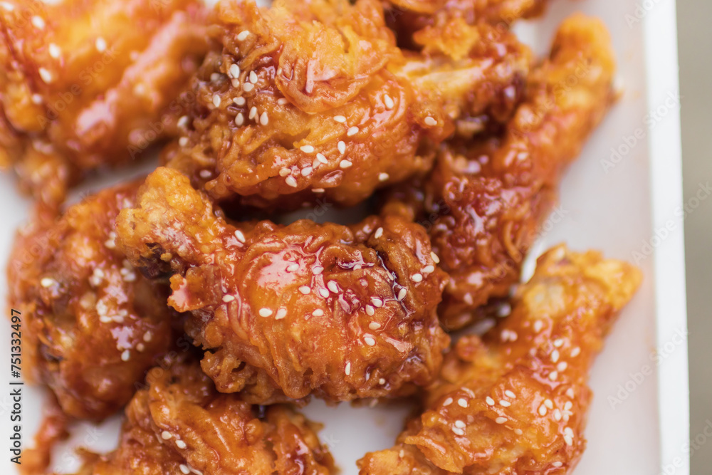 Deep fried chicken wing with spicy sauce in Korean style. Deep fried chicken wing with spicy sauce in Korean style.