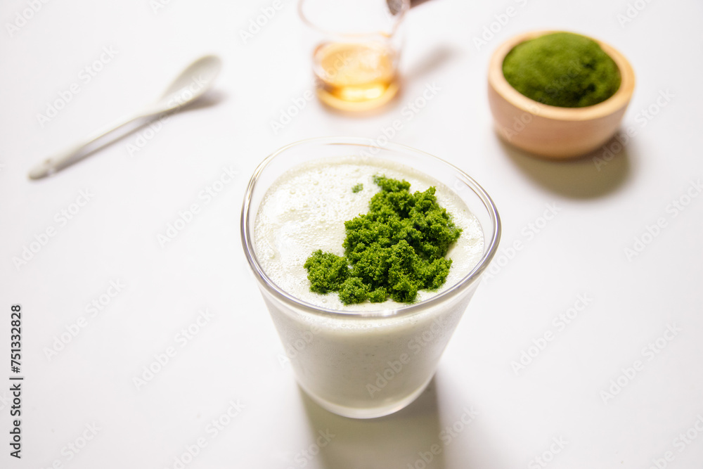 Healthy smoothie with greek yogurt and wolffia globosa in glass isolated on white table background. Wolffia globosa is the nutrient-rich plant-based source of protein and omega3 and vital minerals. Healthy smoothie with greek yogurt and wolffia globosa in glass isolated on white table background. Wolffia globosa is the nutrient-rich plant-based source of protein and omega3 and vital minerals.
