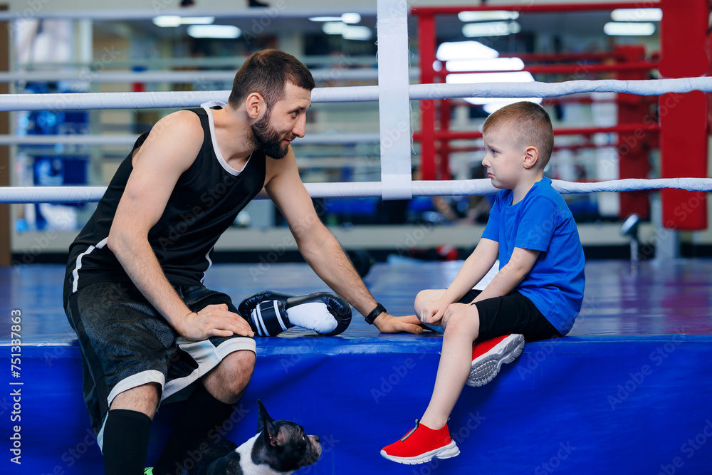 Boxing trainer talks to boy boxer, child lost fight in ring. Concept psychology in sports
