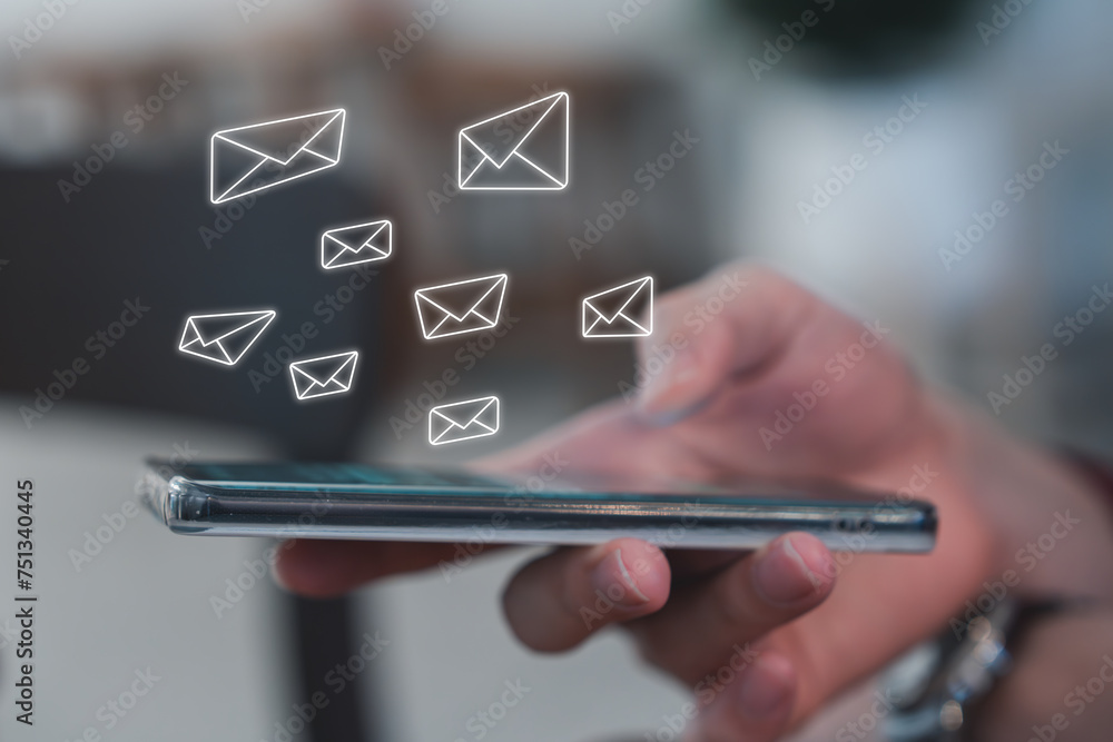 E-mail spam or email marketing concept. Hand using mobile smartphone and receive new multiple email. E-mail spam or email marketing concept. Hand using mobile smartphone and receive new multiple email.