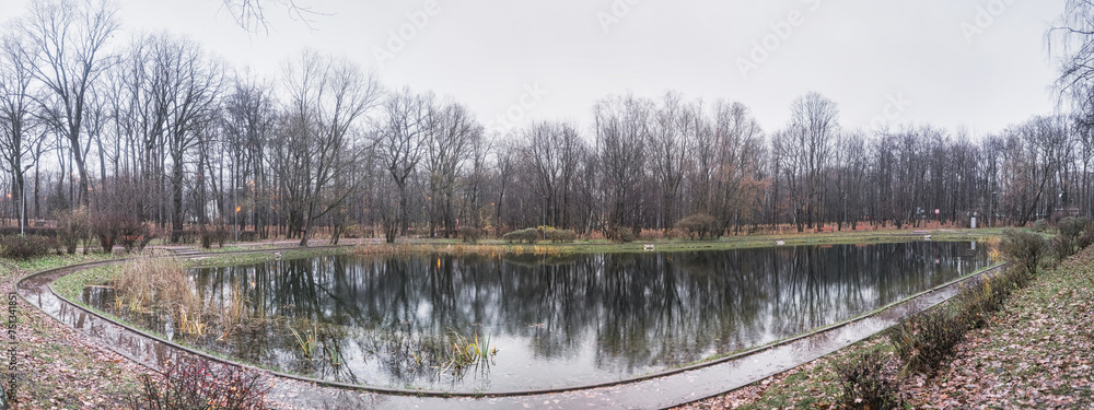 panoramic view of a small lake in an autumn park