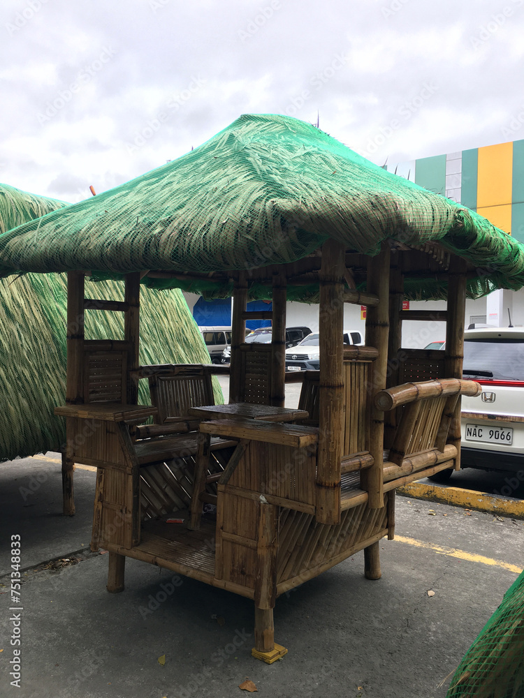 bamboo hut displayed on the parking lot with products for sale bamboo hut displayed on the parking lot with products for sale