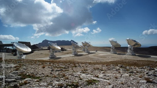 Wide static shot of the Plateau de Bure radio telescope array in France. Ground-level wide shot of large millimeter-wave radio astronomy antennas. photo