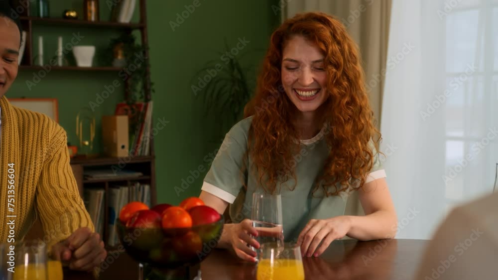 multiracial friends hanging out together at home sitting and chatting. young African man and red haired woman talk and smile. joyful and cheerful male and female students leisure on weekend together multiracial friends hanging out together at home sitting and chatting. young African man and red haired woman talk and smile. joyful and cheerful male and female students leisure on weekend together