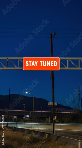 Red signpost with the words Stay tuned against the night landscape backdrop. Stay tuned button concept. Generative AI
