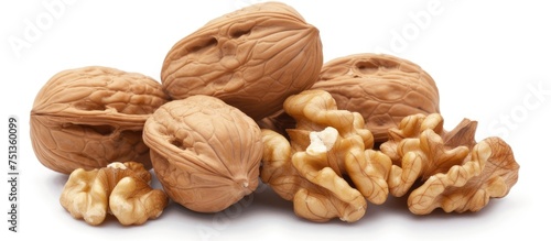 A grouping of whole walnuts is neatly arranged on a plain white background. The walnuts are displayed alongside emptied shells or skins, creating a contrasting image.