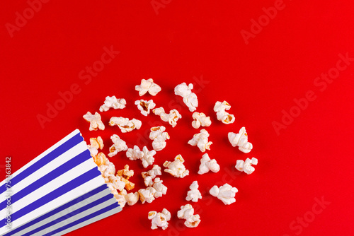 box with popcorn striped in different colors on a red background