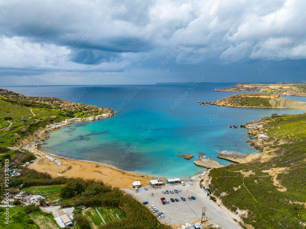 Aerial view of Gnejna Bay and sea, stormy winter sky. Malta country