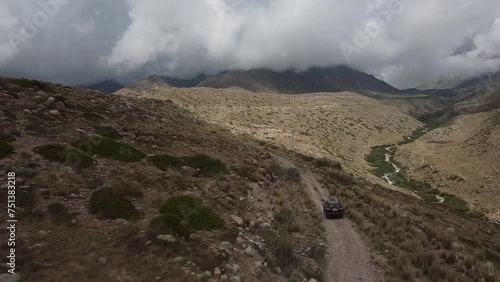 Drone: flies behind a car through a gorge in the mountains of Kyrgyzstan