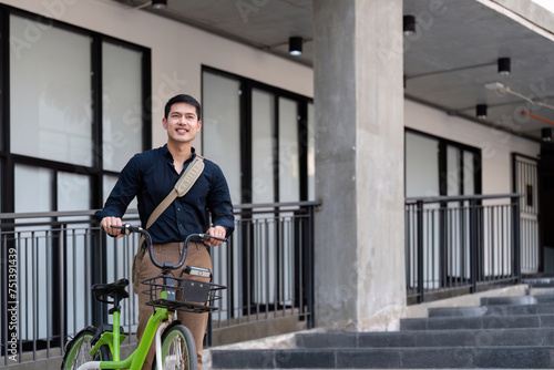 Eco friendly, Happy lifestyle asian young businessman ride bicycle go to office work at city street with bicycle in morning