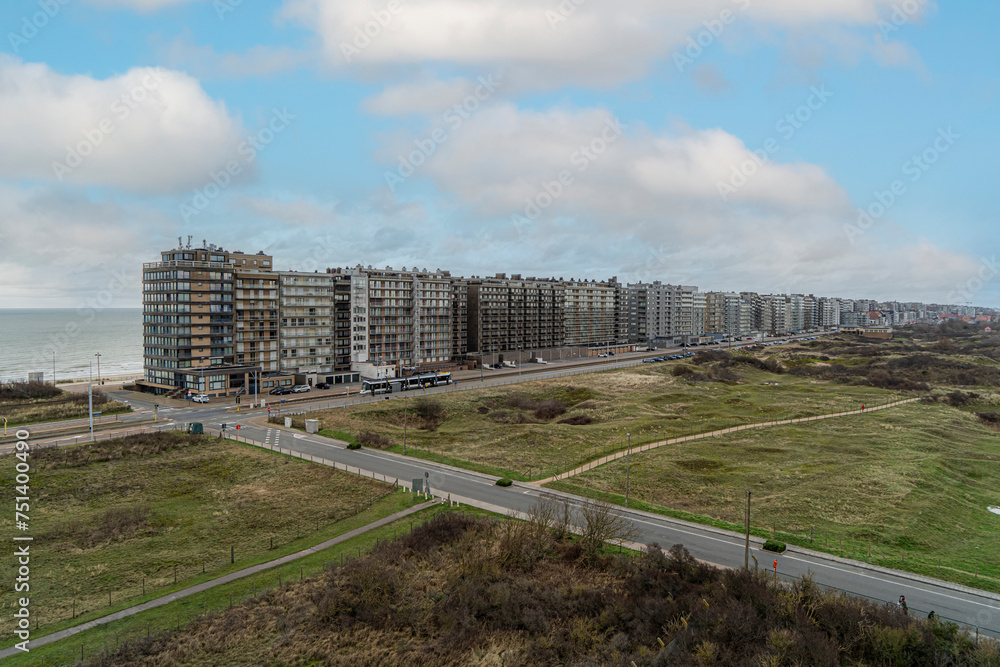 a panorama of the coastline of the apartments along the North Sea in Middelkerke Belgium and a beautiful view of the dunes and nature reserve for walking together with beautiful weather conditions
