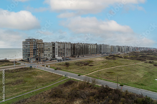 a panorama of the coastline of the apartments along the North Sea in Middelkerke Belgium and a beautiful view of the dunes and nature reserve for walking together with beautiful weather conditions