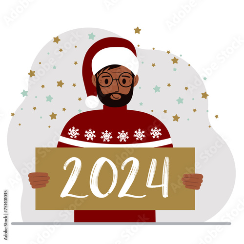A man in a Christmas red hat with snowflakes holds a Happy New Year 2024 card.