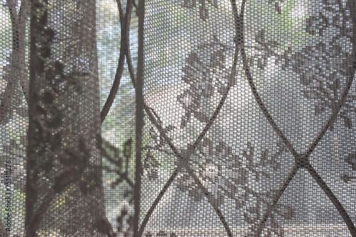 see through transparent curtains and curved steel of a window
