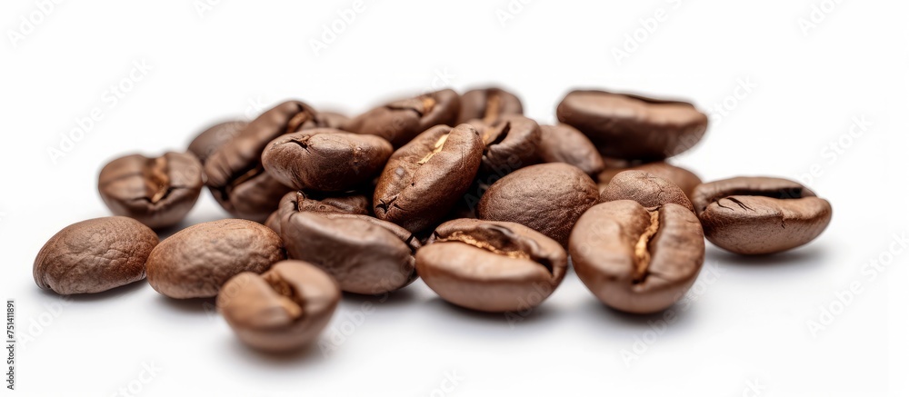 Aromatic Roasted Coffee Beans Scattered on a Clean White Background for Coffee Lovers and Baristas Aromatic Roasted Coffee Beans Scattered on a Clean White Background for Coffee Lovers and Baristas