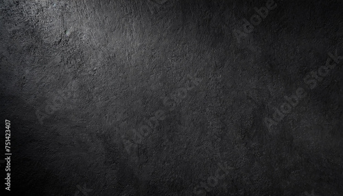 black wall rough texture background concrete floor or old grunge backdrop illuminated by sun ray close up of dark graphite surface for modern background design concept of textures and background