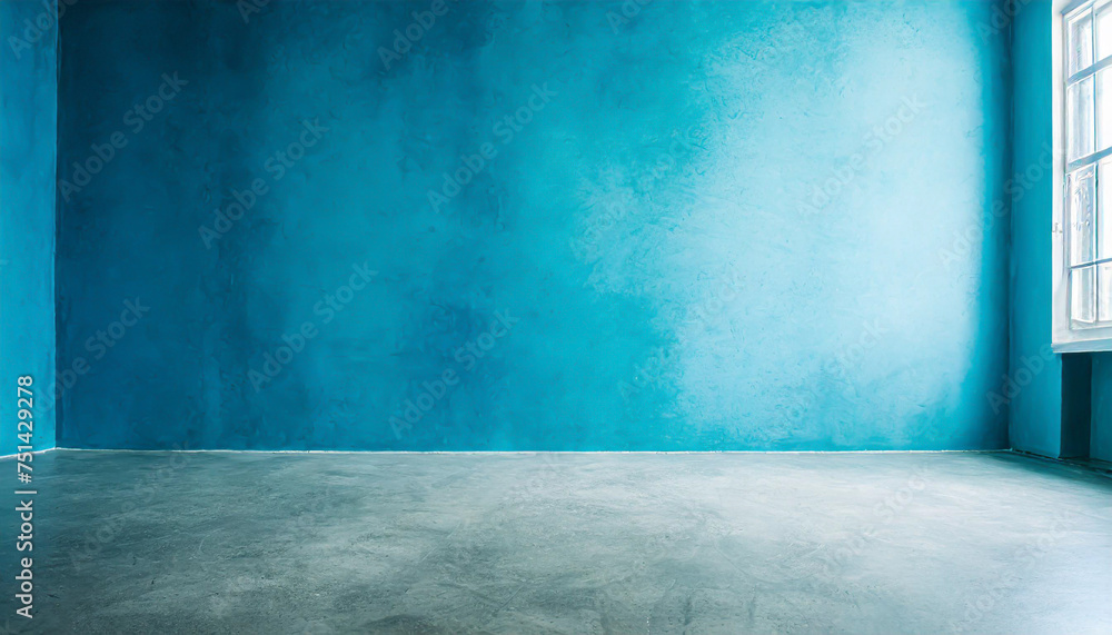 Blue wall in an empty room with concrete floor Blue wall in an empty room with concrete floor