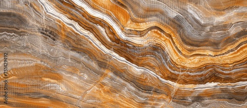 This close-up view showcases a brown and white marble exhibiting its unique natural patterns and colors. The intricate details and contrasting shades of the marble are highlighted in this shot.