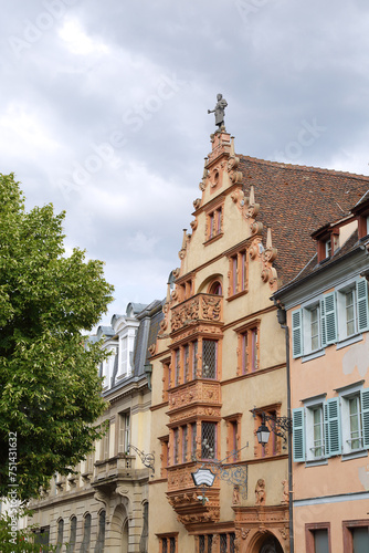 View of one street of the city of Colmar with the medieval house Maison des Tetes, France