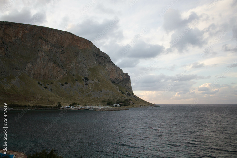 evocative image of sea coast with promontory on the background in Sicily, Italy
