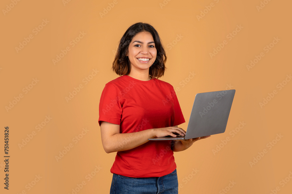 Smiling Young Arabic Woman Freelancer Using Laptop Computer Smiling Young Arabic Woman Freelancer Using Laptop Computer