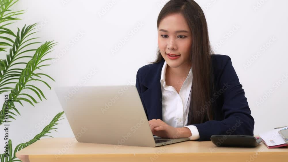 Happy young Asian women startup entrepreneur happy and excited smiling after getting email for success sign business contact, happy girl on the workplace. Distance learning online education and work. Happy young Asian women startup entrepreneur happy and excited smiling after getting email for success sign business contact, happy girl on the workplace. Distance learning online education and work.