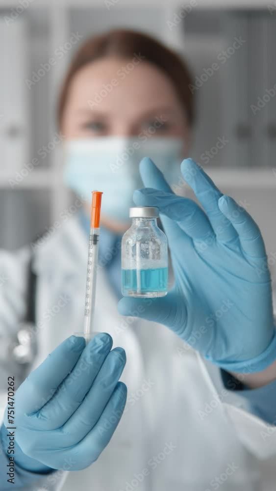 A doctor holding a syringe with an antiviral drug prepares for vaccination, emphasizing the importance medical profession and fight against diseases. Health care and disease prevention during epidemic A doctor holding a syringe with an antiviral drug prepares for vaccination, emphasizing the importance medical profession and fight against diseases. Health care and disease prevention during epidemic
